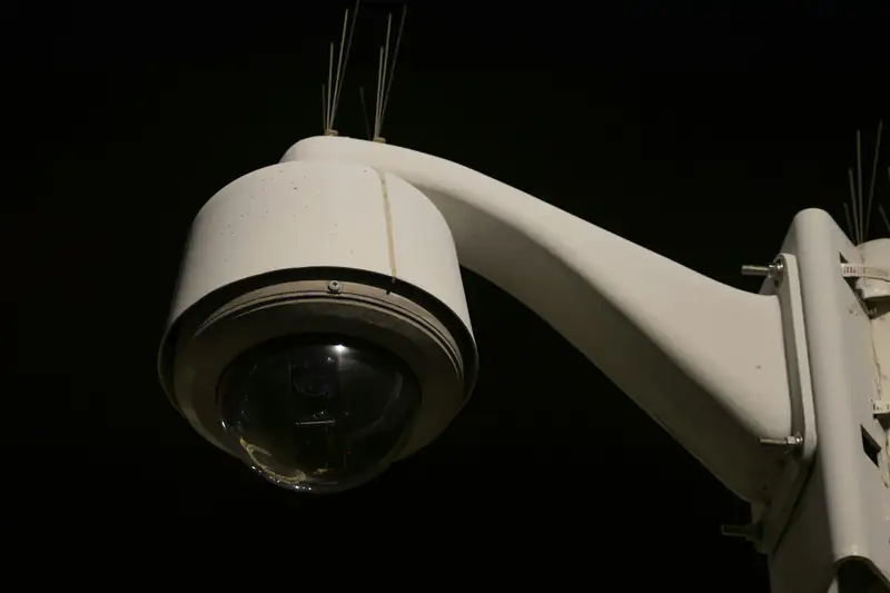 Dome security camera on a building at night